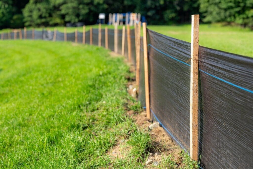 A fence constructed from black plastic and wood materials showcasing a modern design