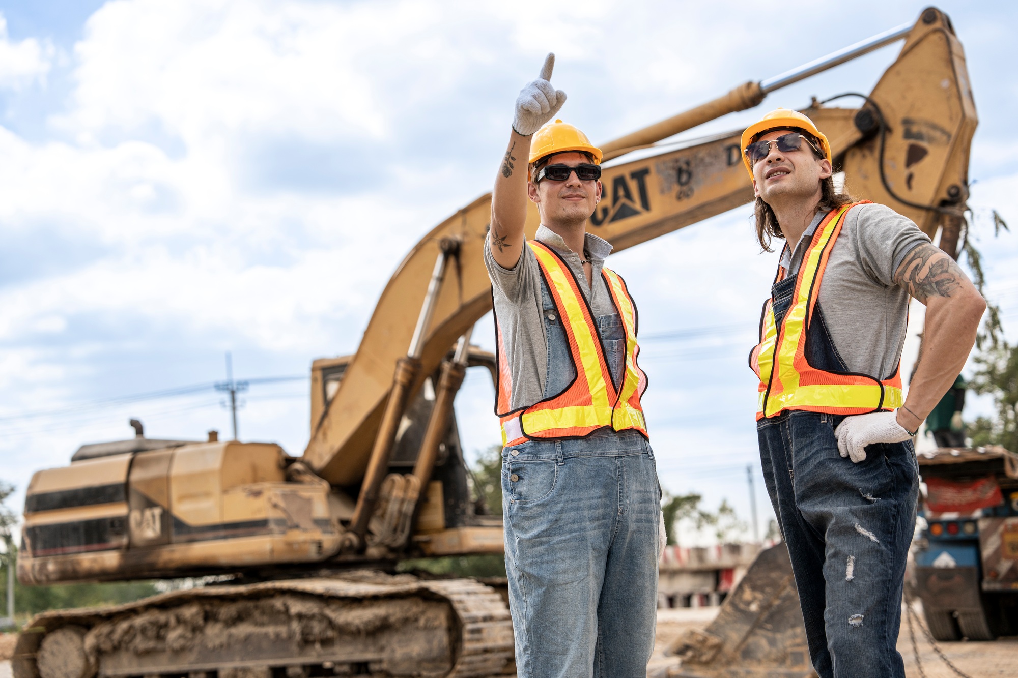 Construction workers standing at a busy construction site