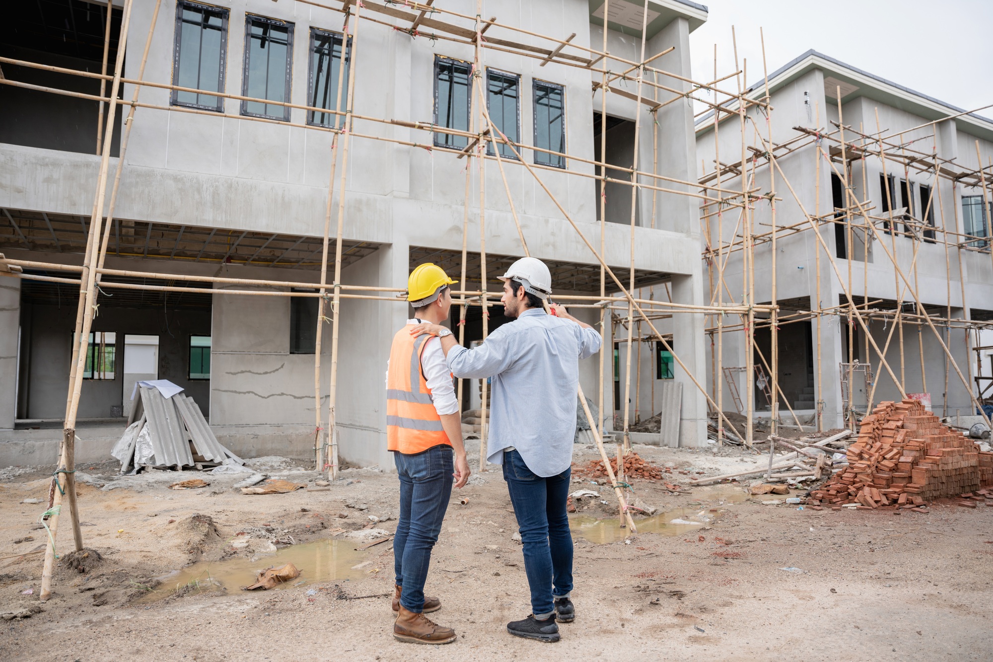 The engineer manager and foremen discussed the site projects on the construction site.