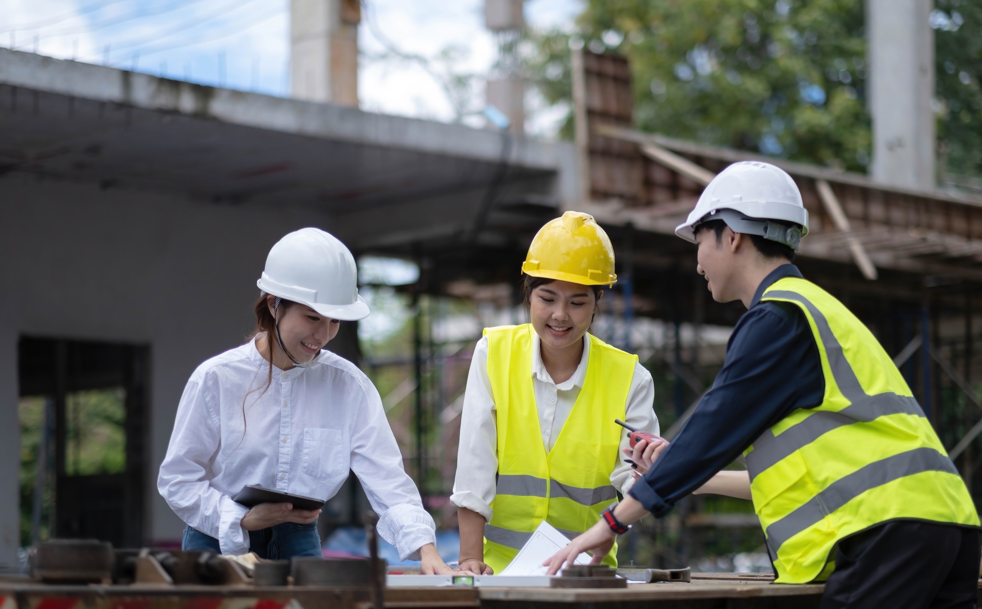 Three experts inspect commercial building construction sites, industrial buildings real estate